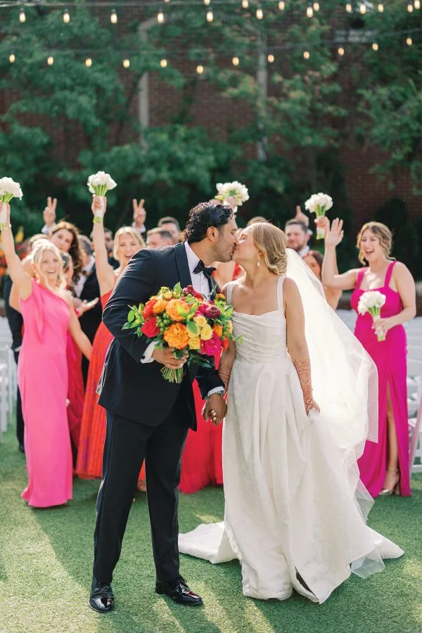 Brightly colored wedding party with bridal bouquet from Belli Fiori in St. Louis.