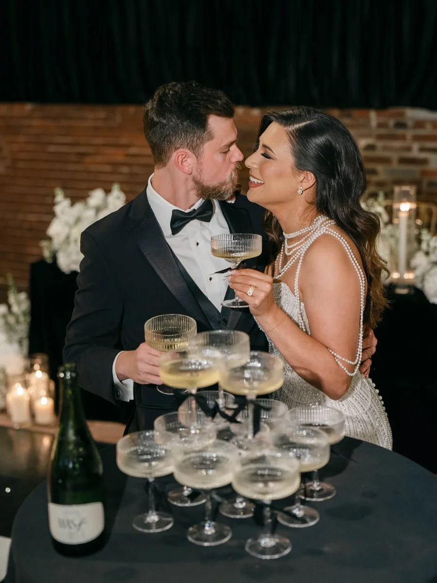 Bride and groom with a champagne tower at the Gatsby Events Venue in St. Louis.