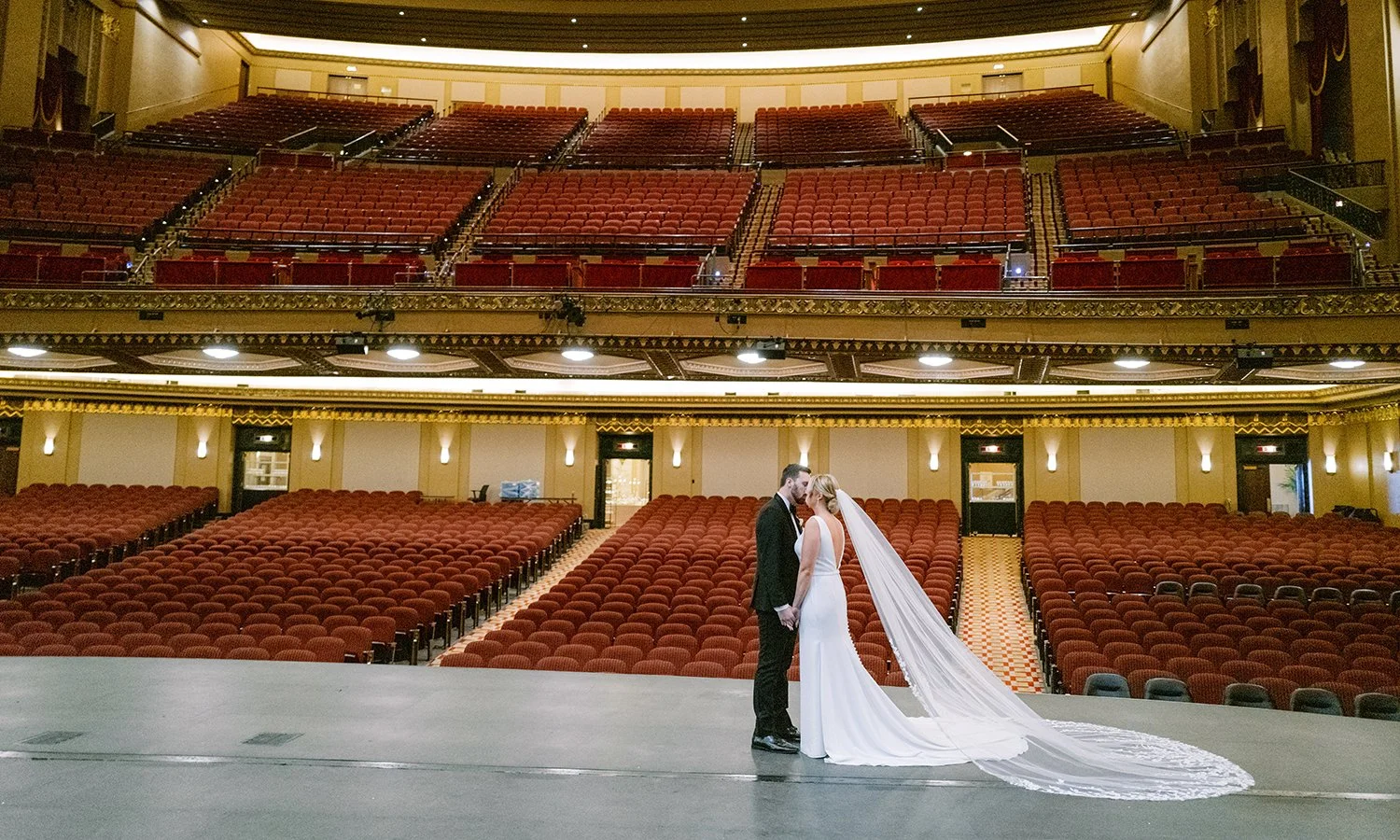 Bride and groom on the stage of the Stifel Theater in St. Louis.
