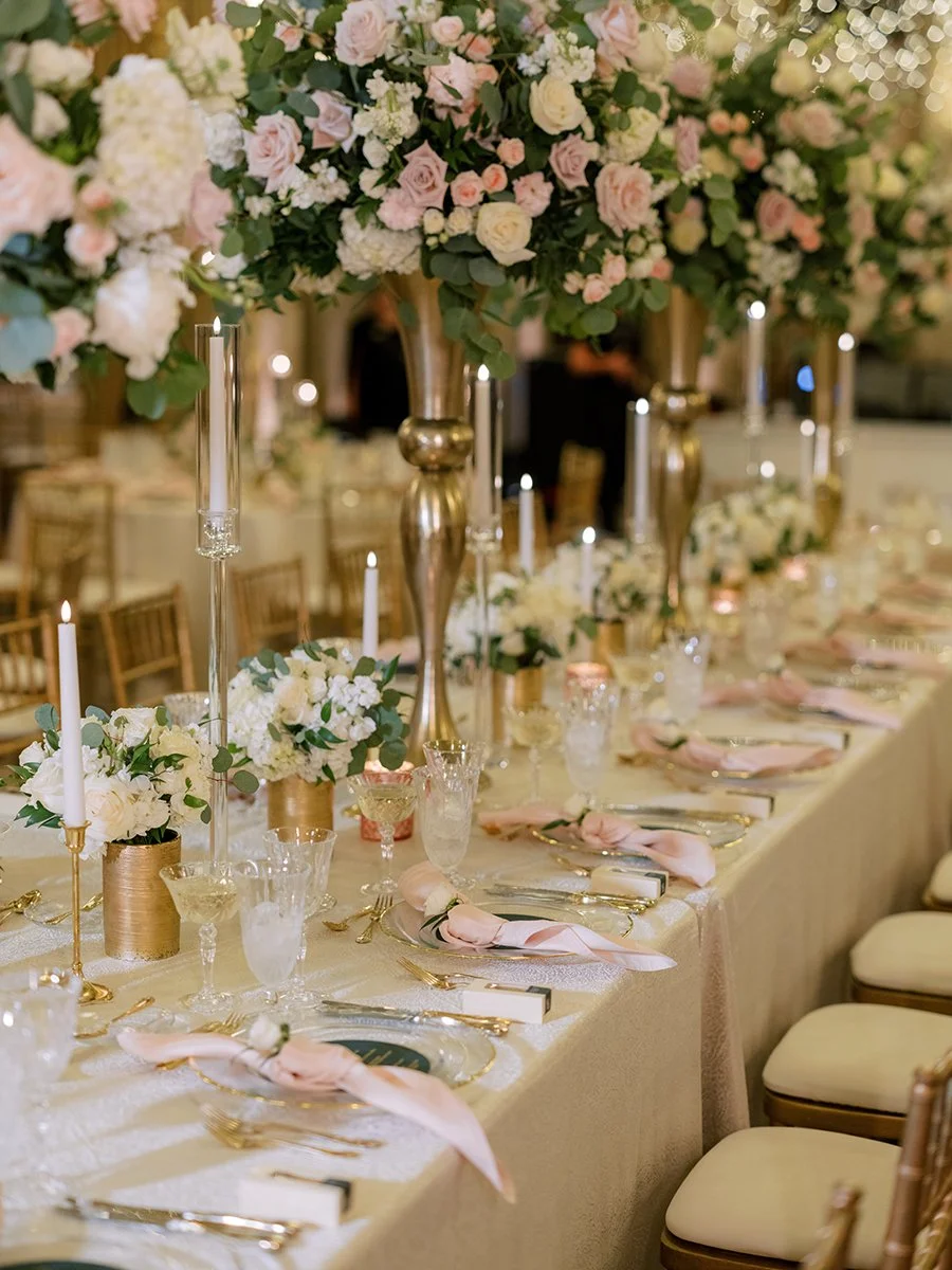 Wedding head table with blush and white rose centerpieces at the Stifel Theater in St. Louis.