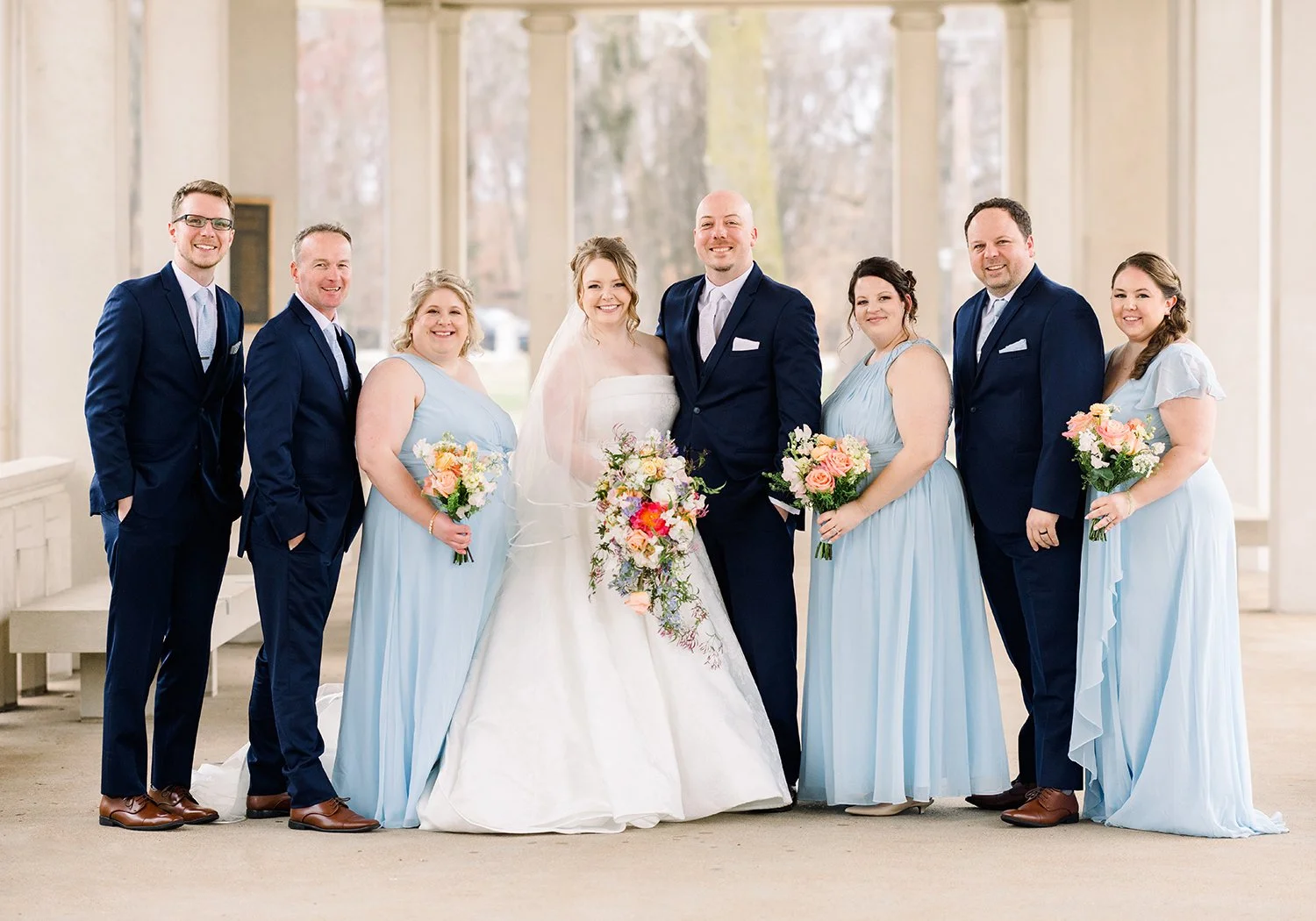 Wedding party with cascading bouquets designed by wedding florist Belli Fiori in St. Louis.
