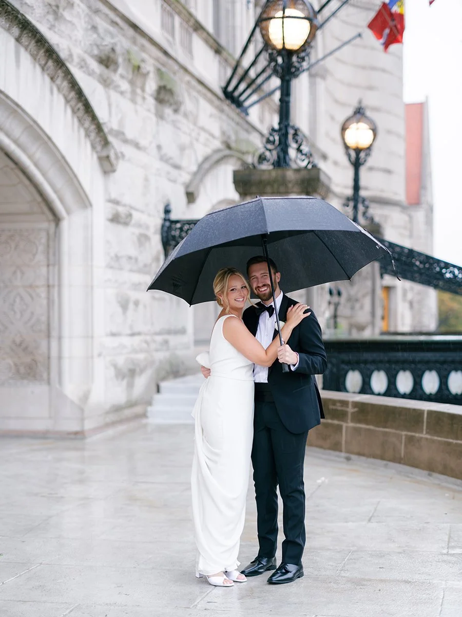 Bride and groom standing out from of Union Station in St. Louis.
