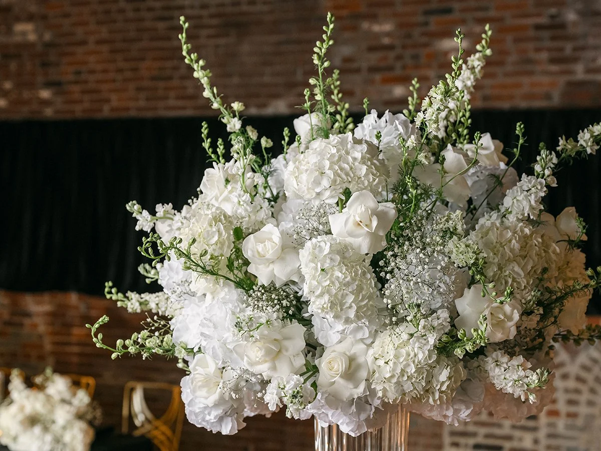 Tall white wedding floral centerpiece with roses and hydrangea at the Gatsby Events Venue in St. Louis.