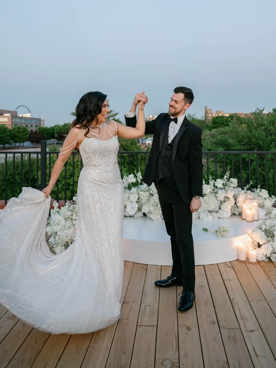 Bride and groom and white flower meadow for wedding ceremony at the Gatsby Events Venue in St. Louis.