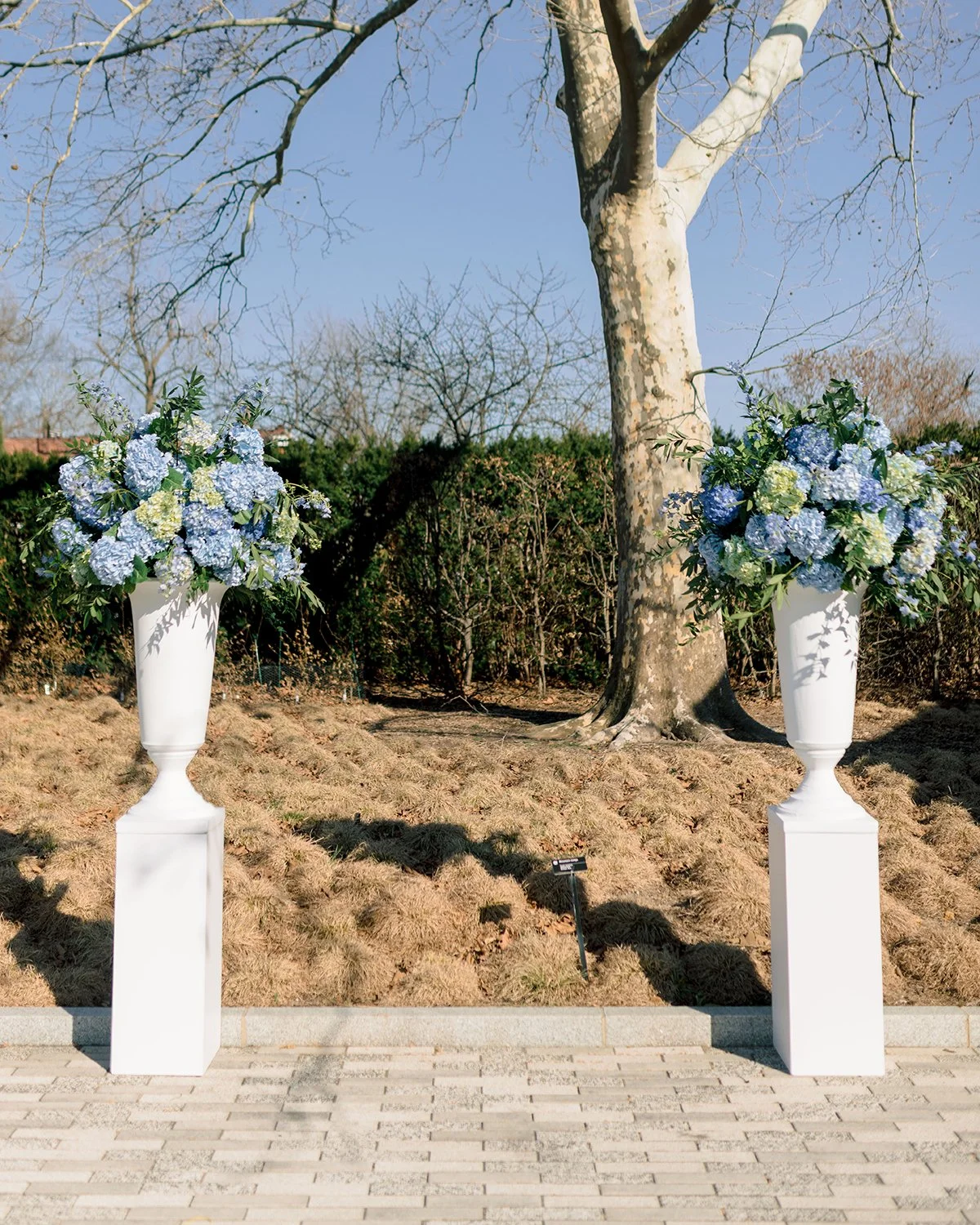 Blue and white wedding ceremony flowers at the Missouri Botanical Garden designed by Belli Fiori.