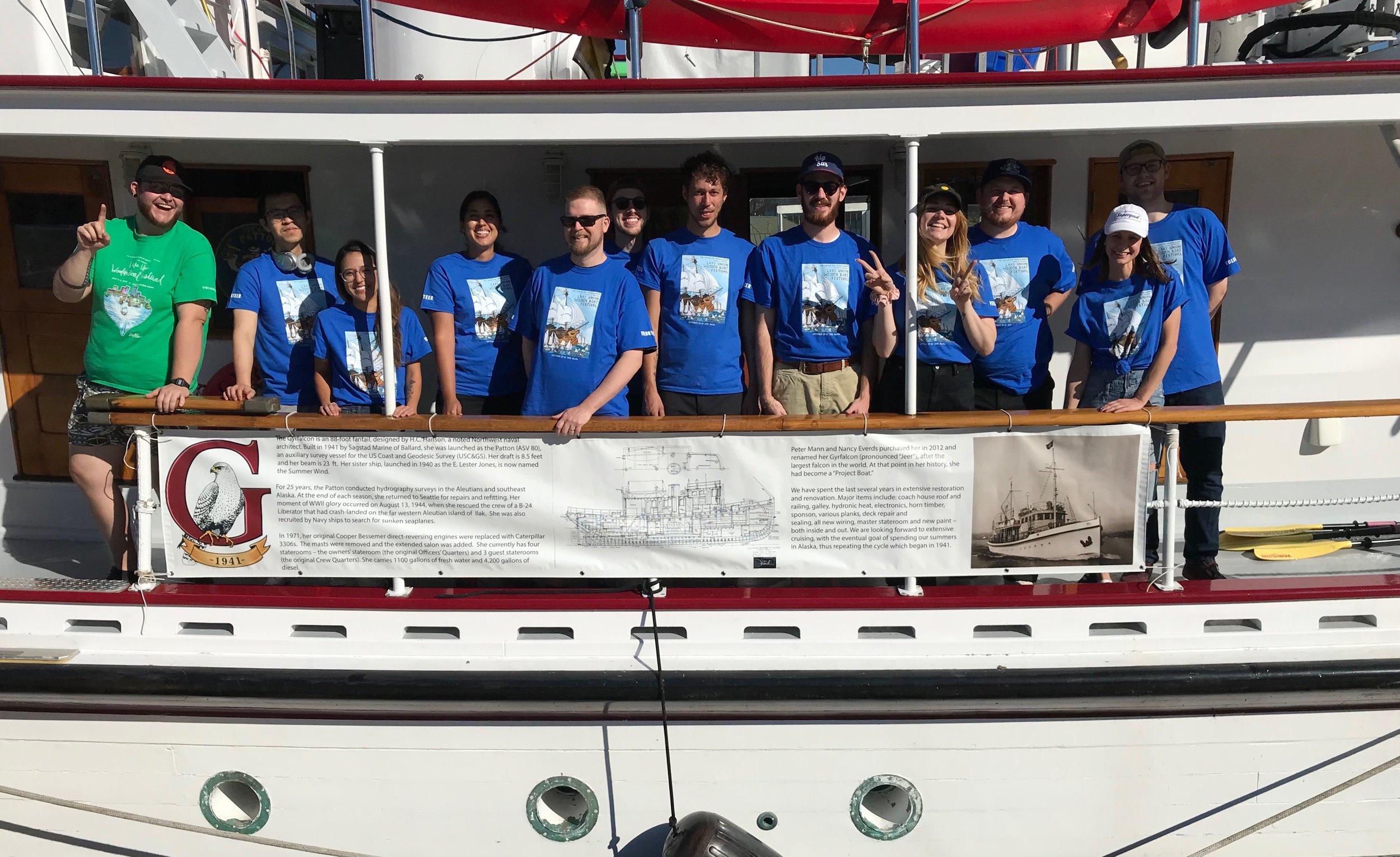 Volunteers gathered on the deck of a large wooden ship during the Wooden Boat Festival