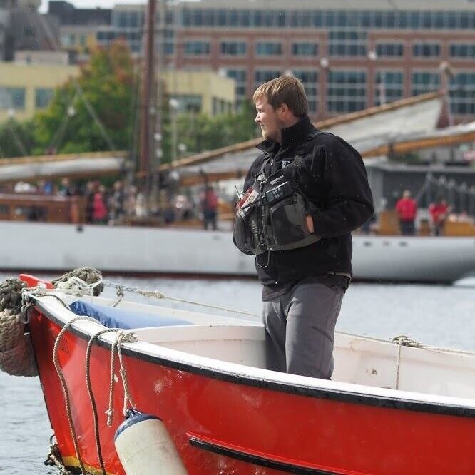 Dustin Espy stands at the bow of safety boat Shane B