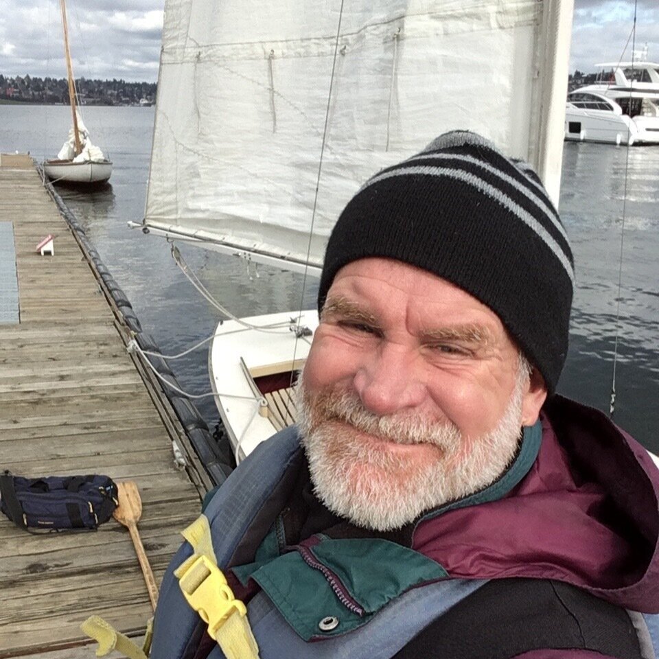 Allen Weymiller stands in front of a rigged sailboat at CWB