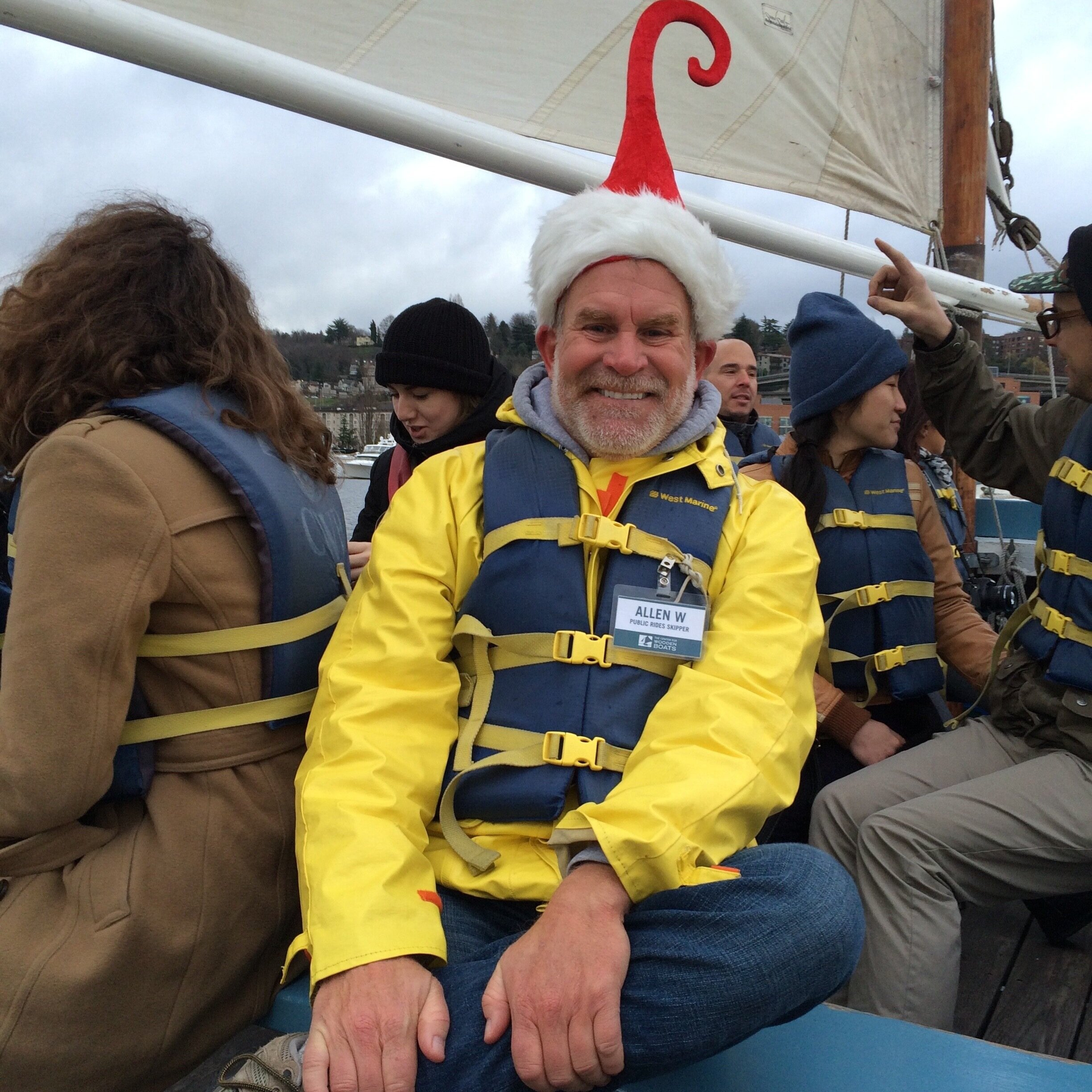 Allen Weymiller, wearing an elf hat, sits in a boat for Sunday Public Sail