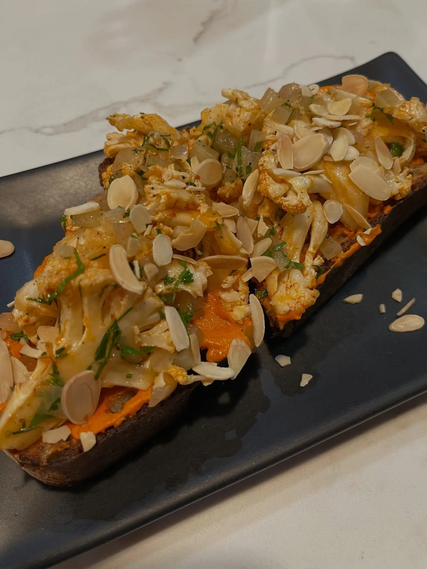 Our most popular VEGAN dish 🌱🌱🌱 Spicy Cauliflower Tartine on fresh sourdough from @rubysbakery_lodi with our housemade romesco + lemon + parsley + fennel + shaved almonds. 

Interested in more vegan options??? Check out our menu linked in our bio 