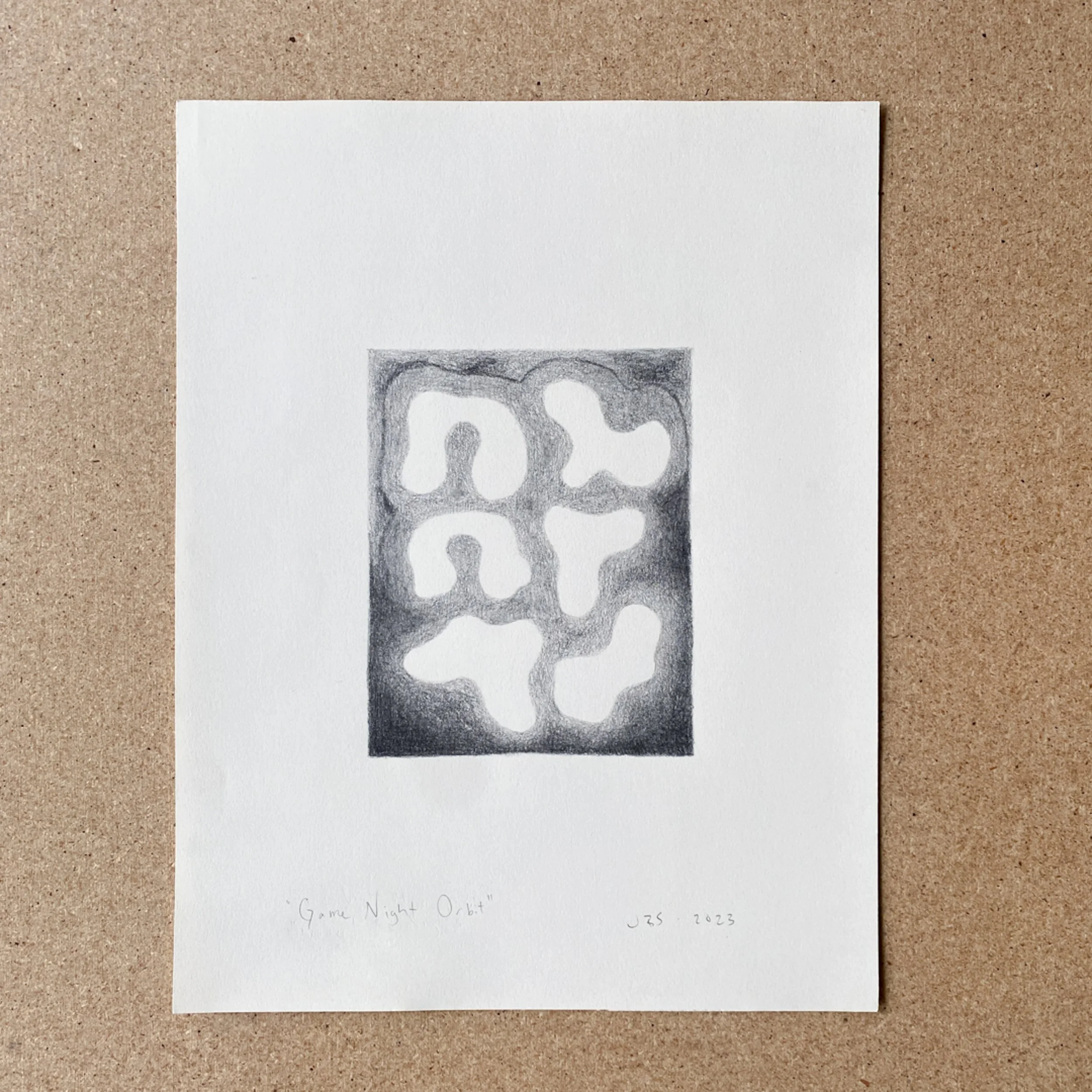 A white sheet of paper with a pencil sketch of an abstract game night orbit design, with handwritten notes and date at the bottom.