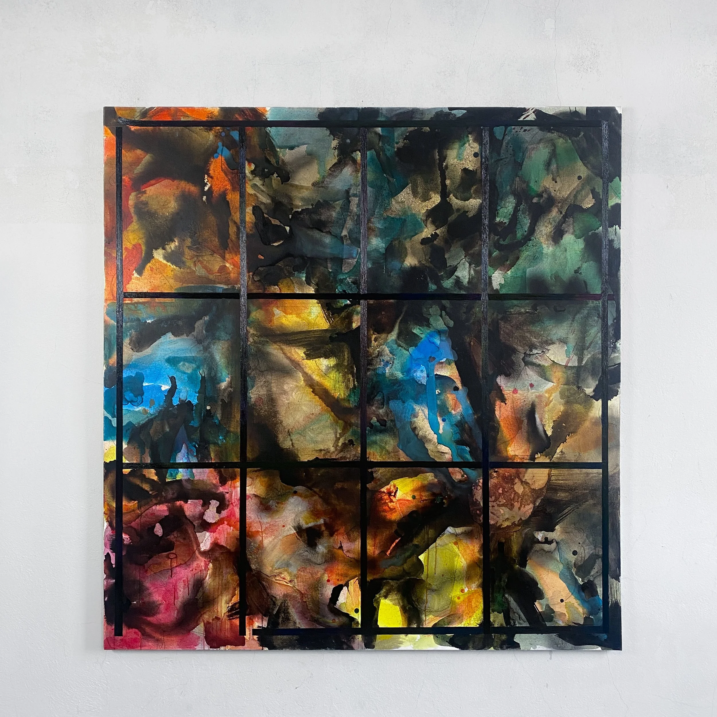 Abstract painting with vibrant splashes of various colors framed with black lines, hanging on a white wall.