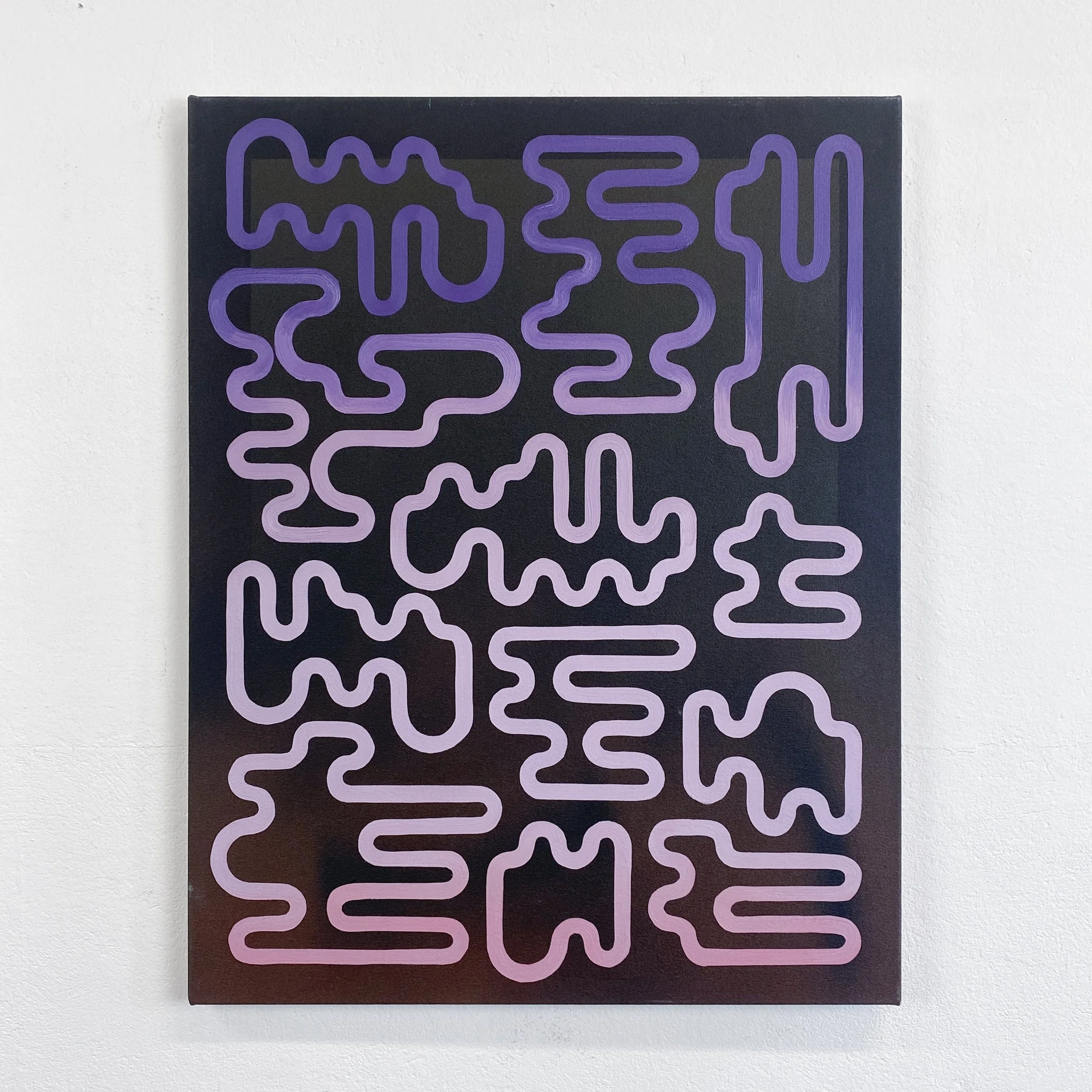 Close-up view of a black picture frame with a purple neon light in a geometric maze pattern hung on a white wall.