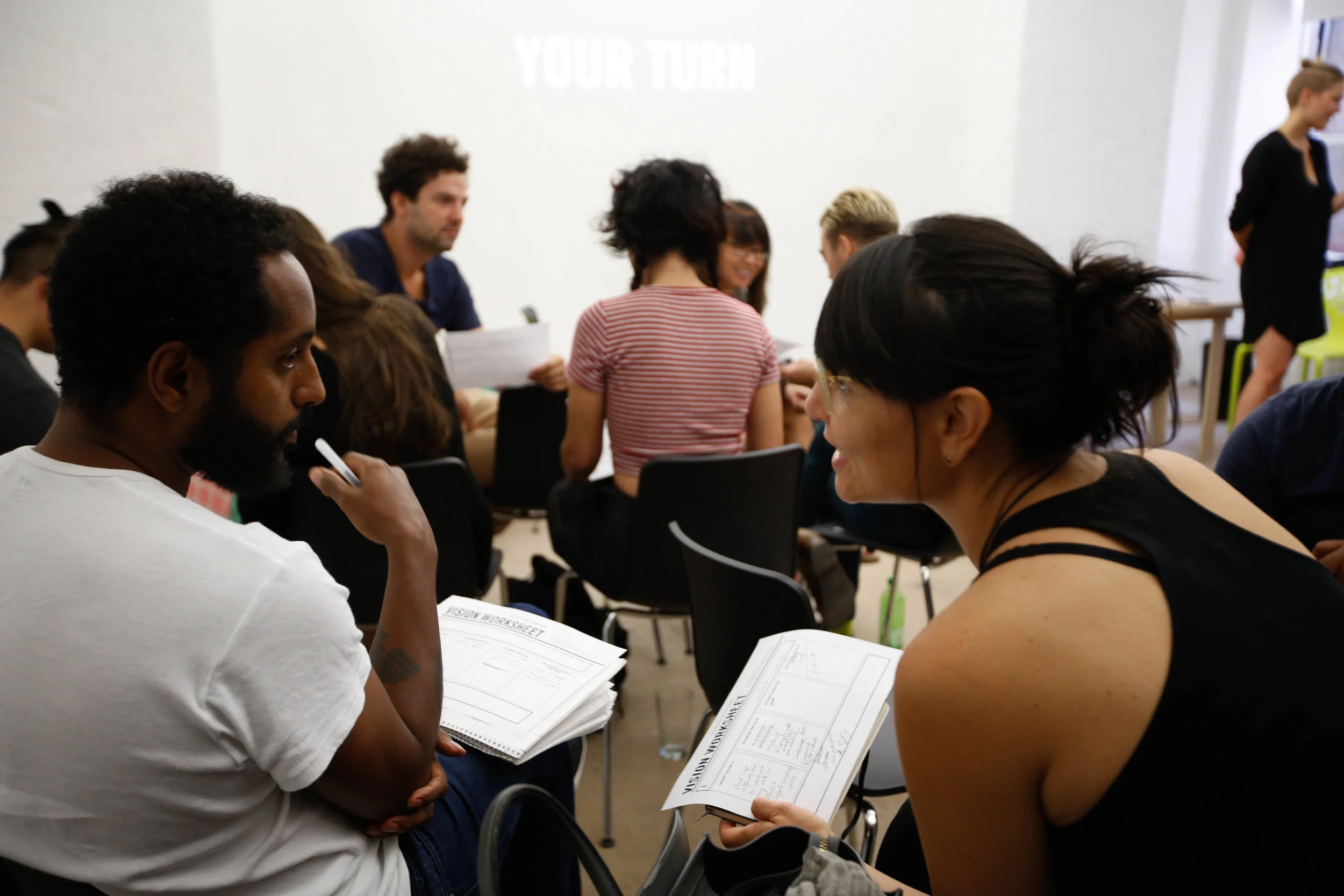 Workshop participants in conversation. Links to Program Overview.