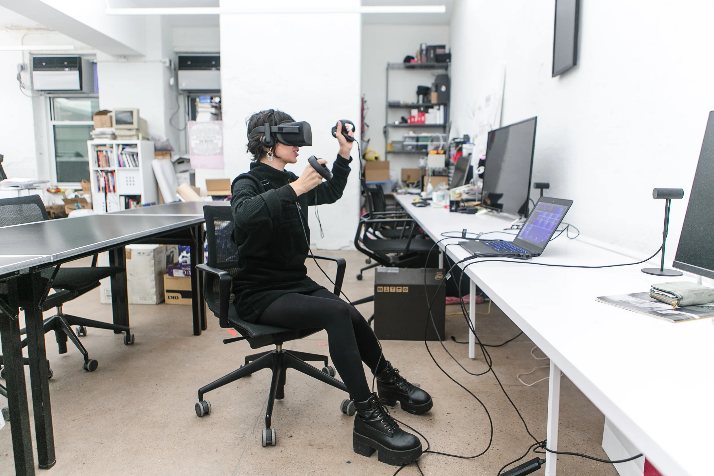 NEW INC member wearing VR goggles