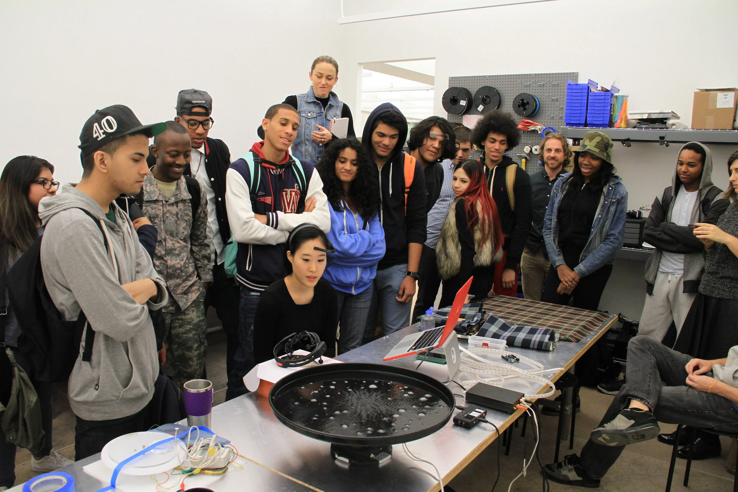 NEW INC member demonstrates for students