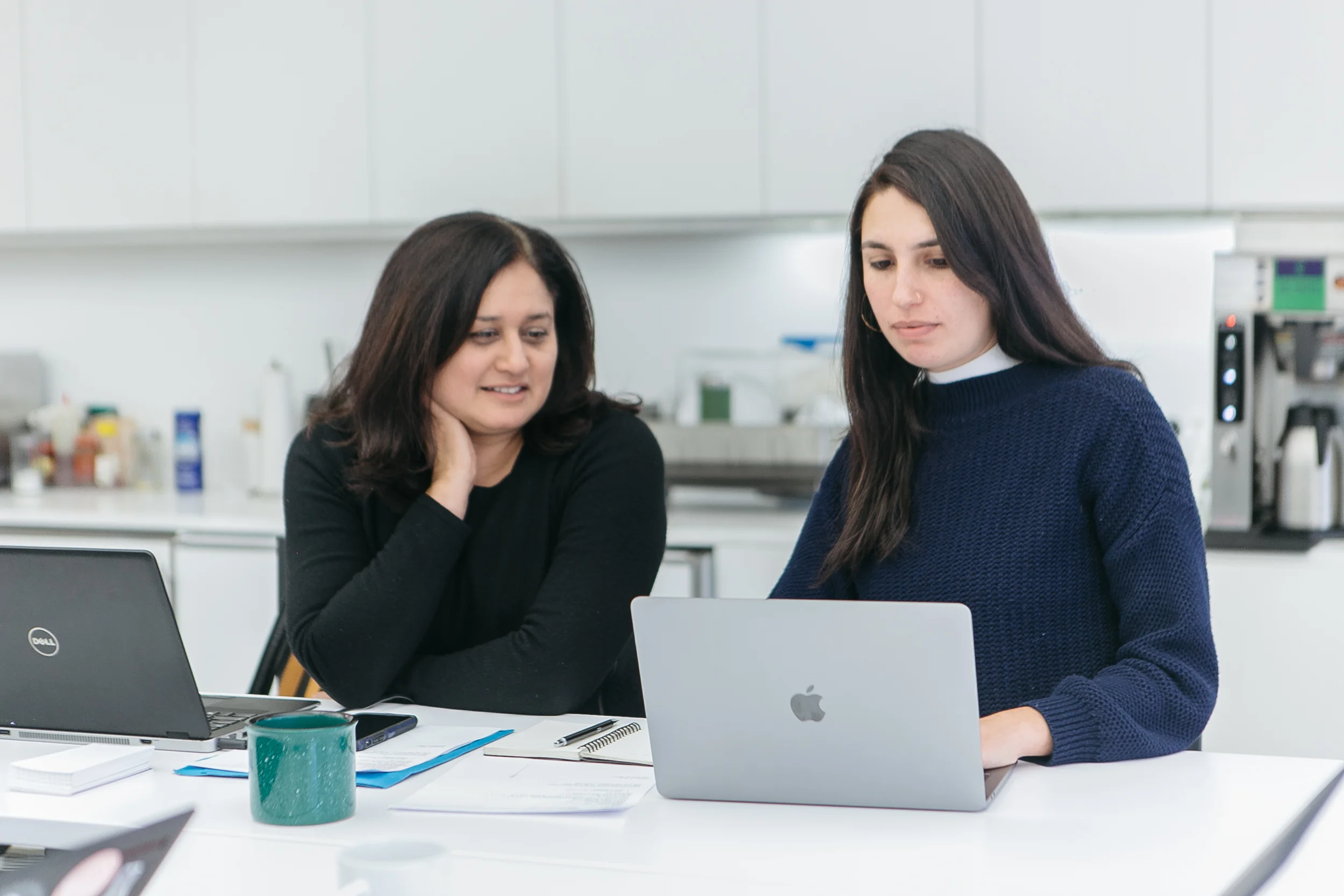 NEW INC members at shared desk