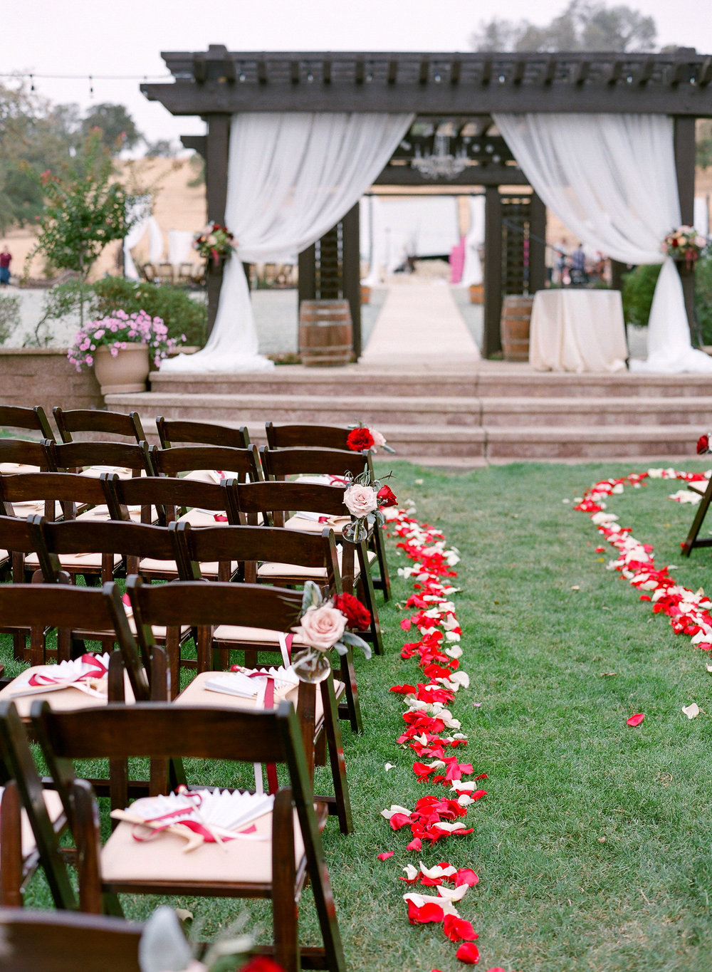 Wedding_Aisle_Arrangements_Petals_Draping_Red_Gold_Pink_Rancho_Victoria_Vineyard_Northern_California.jpg