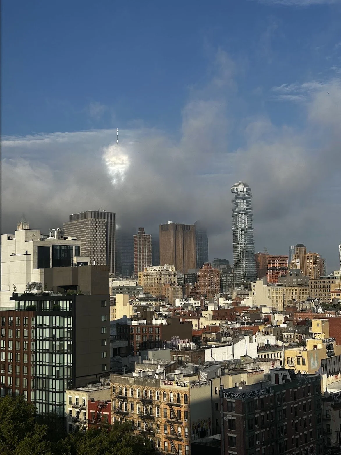 freedom tower behind the clouds