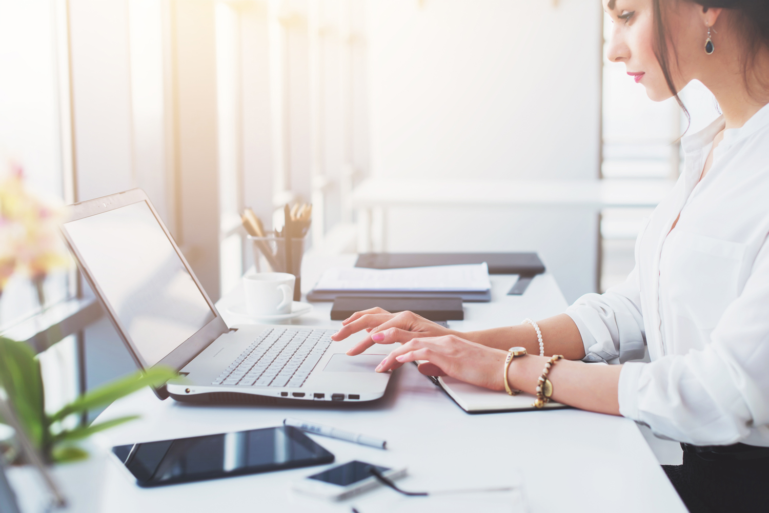 lady-at-desk-bright-phone-laptop.jpg