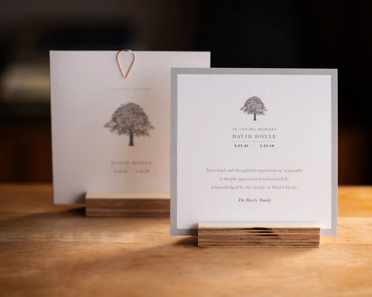 Memorial Card with Tree Motif sitting in a frame on a wooden table