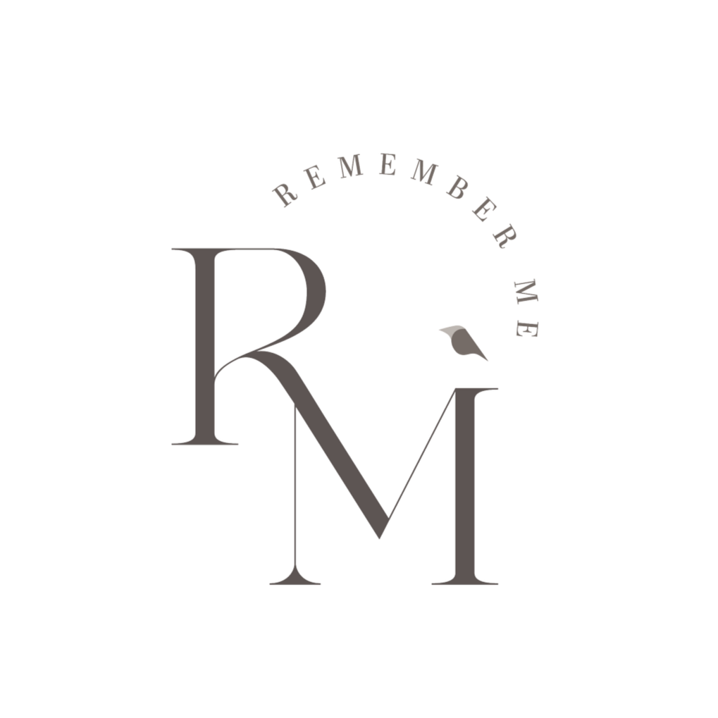 Letter logo with the words "Remember Me" curved above, featuring large stylized letters R, M, and a bird perched on the M.