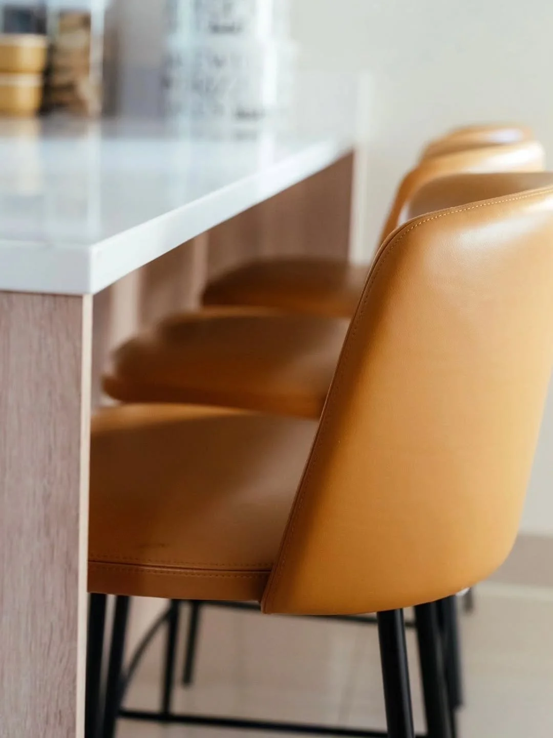 Look at these legs!

With black accents running throughout this home, we were delighted to unveil these bar stools featuring upholstered leather seats and backs for added comfort.

The sleek black metal legs, complete with a footrest, make them both 