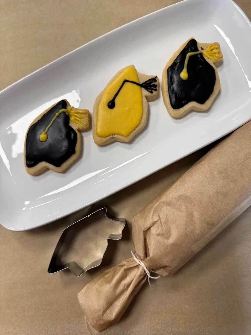 Graduation season is upon us🎓! Fun fact, Alexis&rsquo;s middle child is graduating from high school this year🤯.

We have our v, gf sugar cookie dough available for graduation cookies. Mini-doughnuts or custom cakes are also popular options for grad