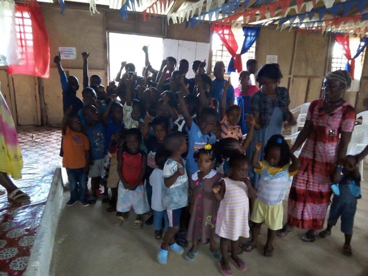 Kids whose families were the victims of Ebola line up to receive their gifts from WFWP USA