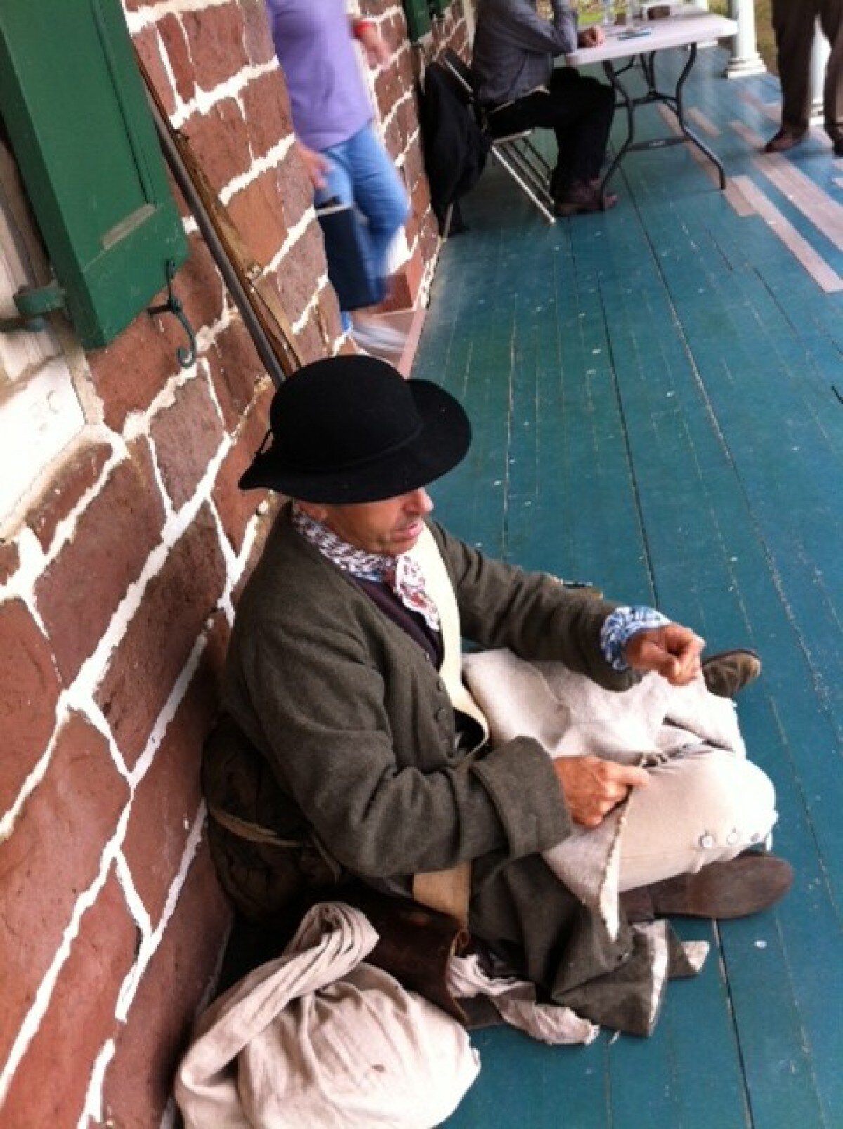 Soldier mending knapsack