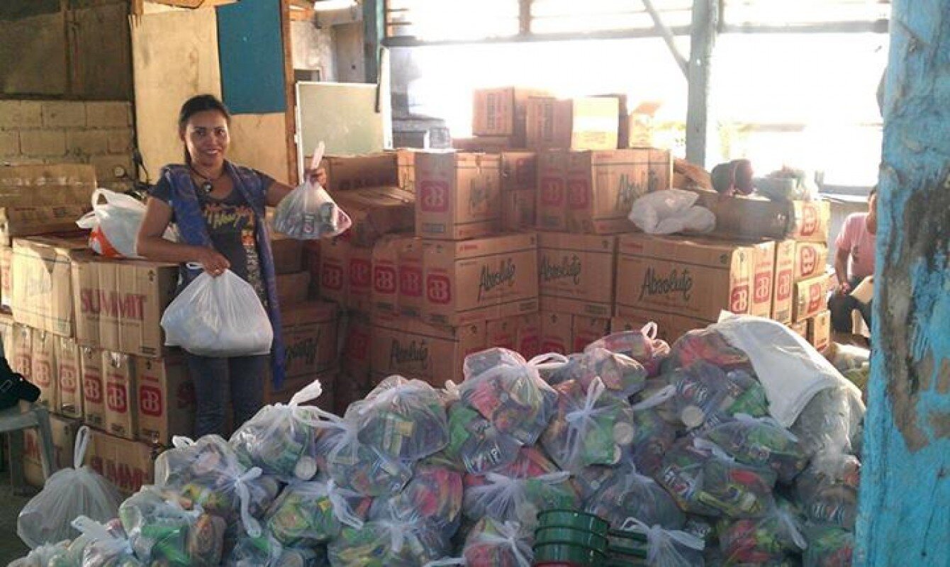 Our WFWP Philippines team distributing goods.