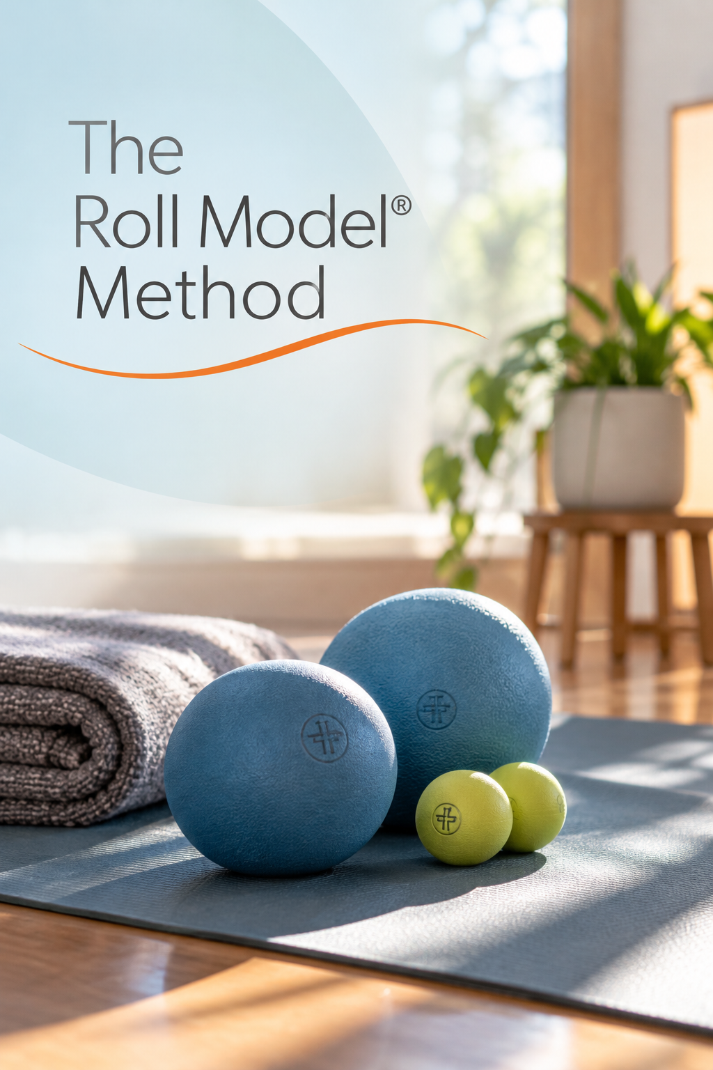 Blue and green self-massage therapy balls arranged on an exercise mat beside a folded towel. Text overlay reads “The Roll Model® Method.”