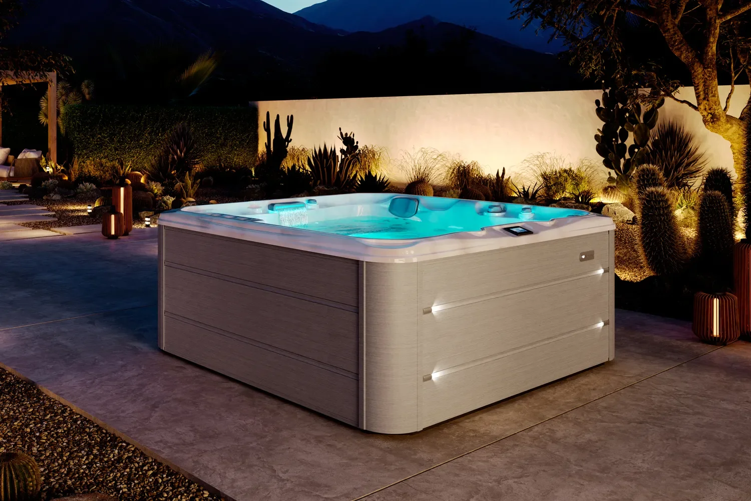 A modern hot tub with glowing blue water is set on a patio at dusk, surrounded by plants and soft outdoor lighting.