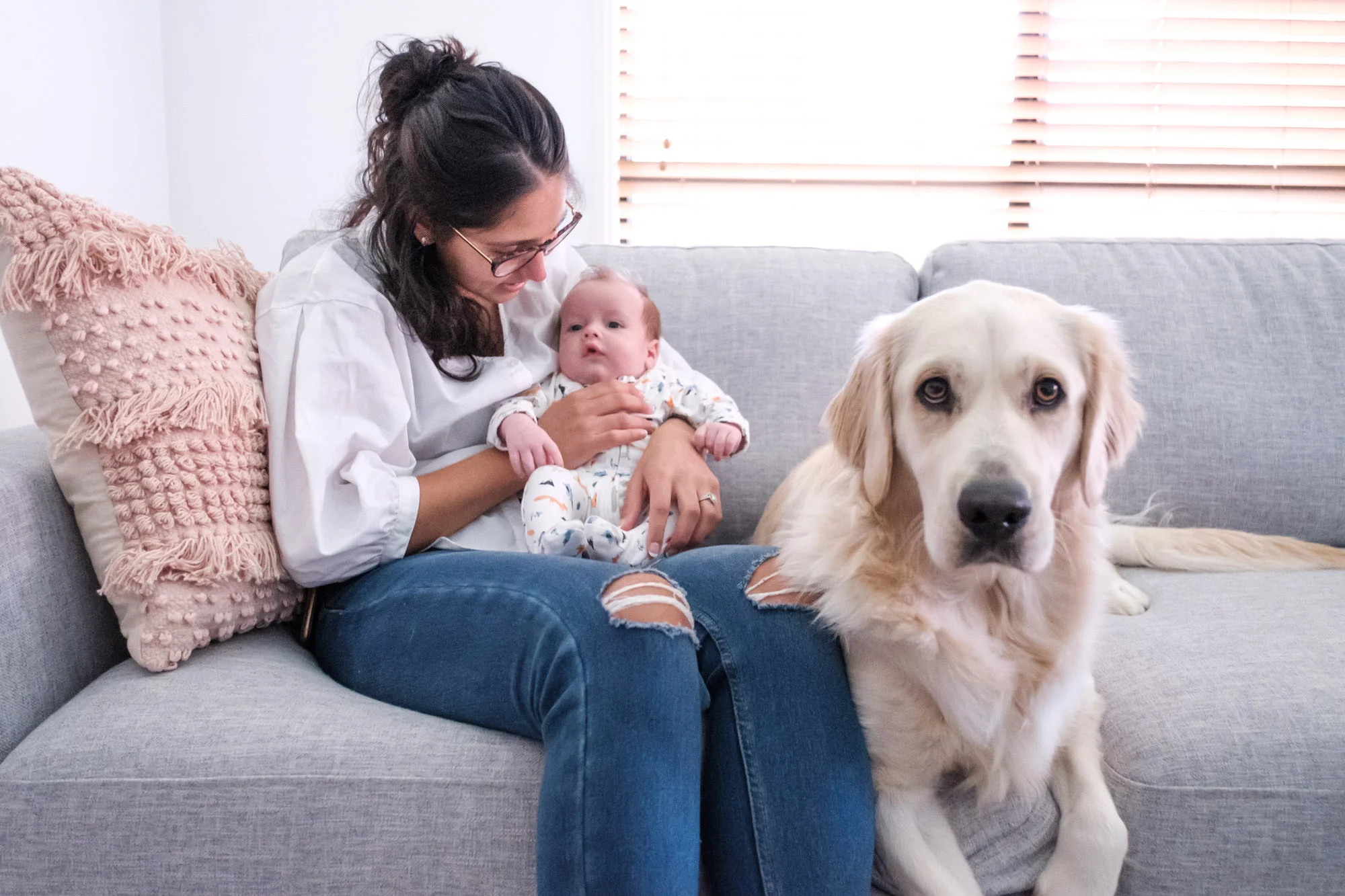 Mother and Newborn on couch in their home with golden retriever. relaxed in-home newborn photography gold coast without props