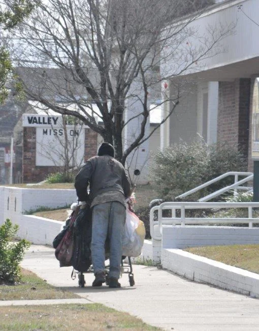 Homeless Man walks in front of Mission.jpg