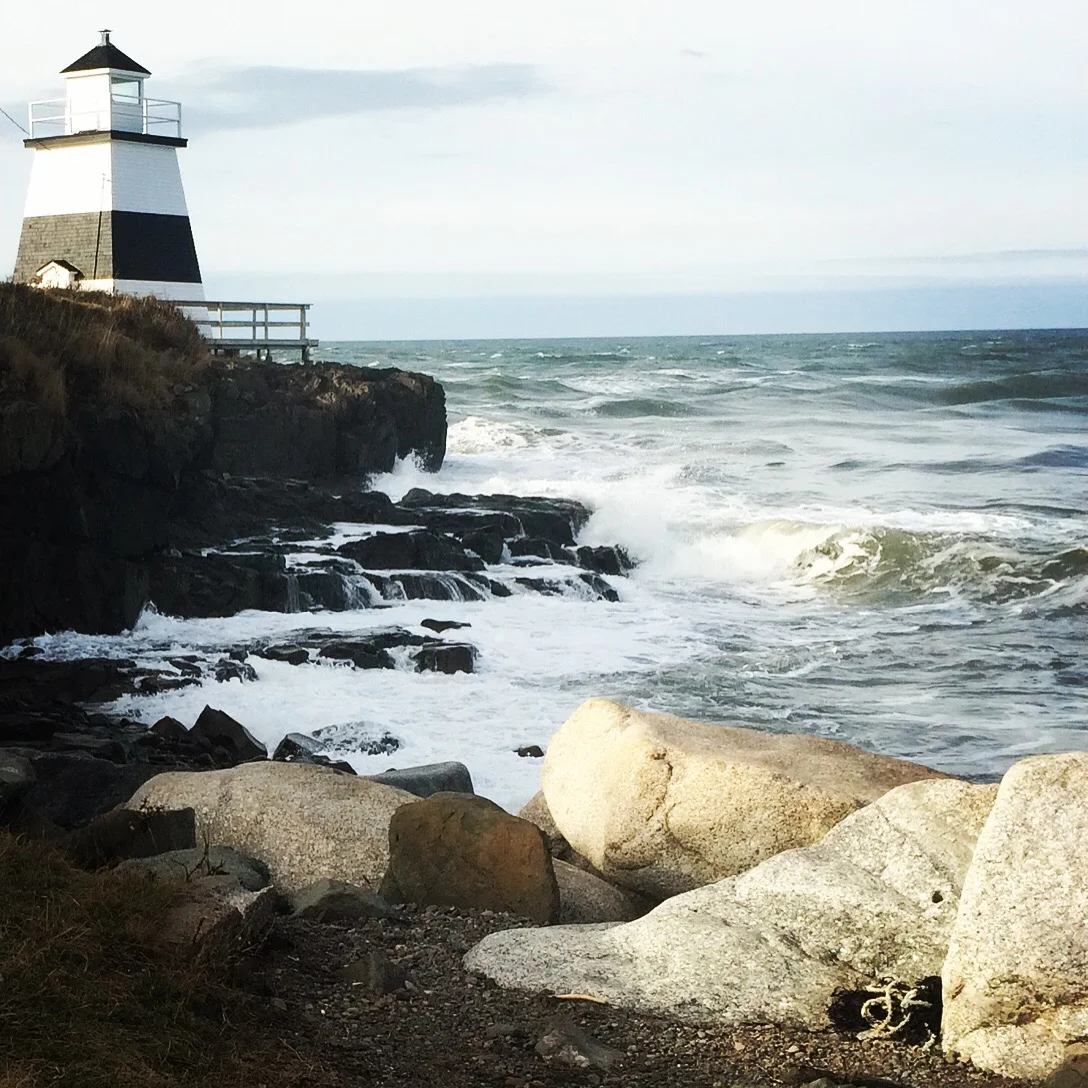 Lighthouse overlooking the rocky Maine coastline