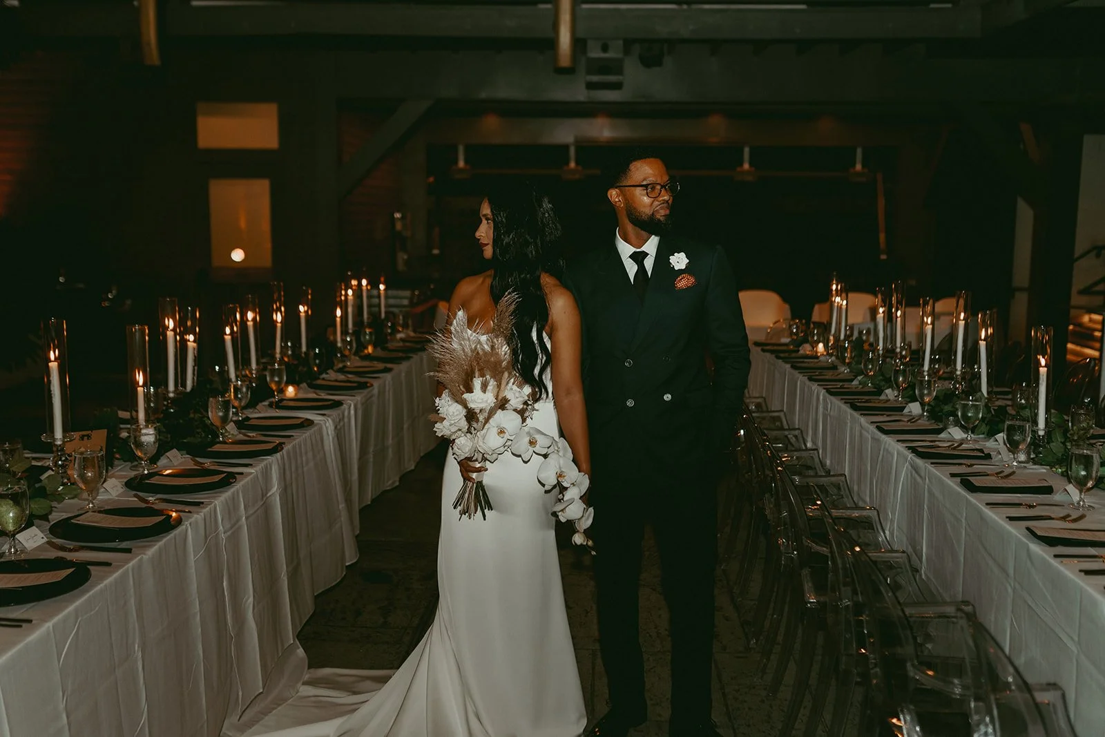 Bride and groom in an Elegant New Orleans historic venue courtyard for their wedding reception featuring candlelit tables and romantic event design.