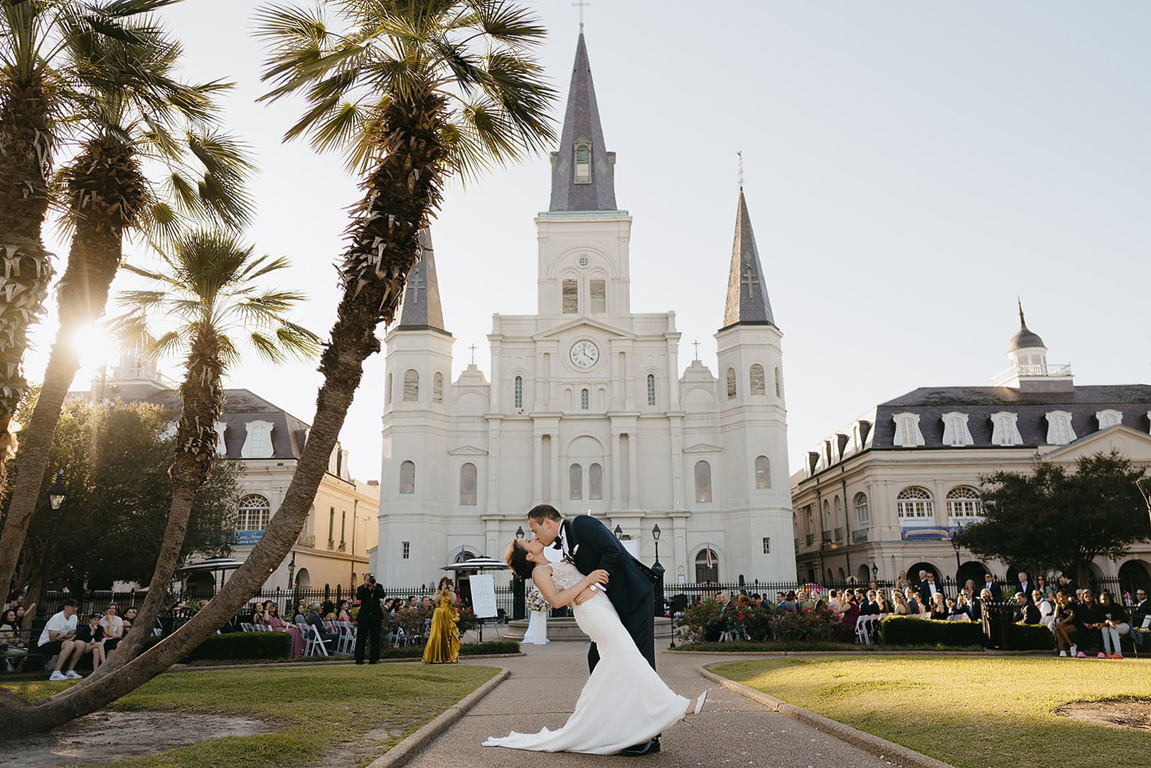 Newlywed couple kissing outside a historic New Orleans church following their outdoor wedding ceremony in Jackson Square.