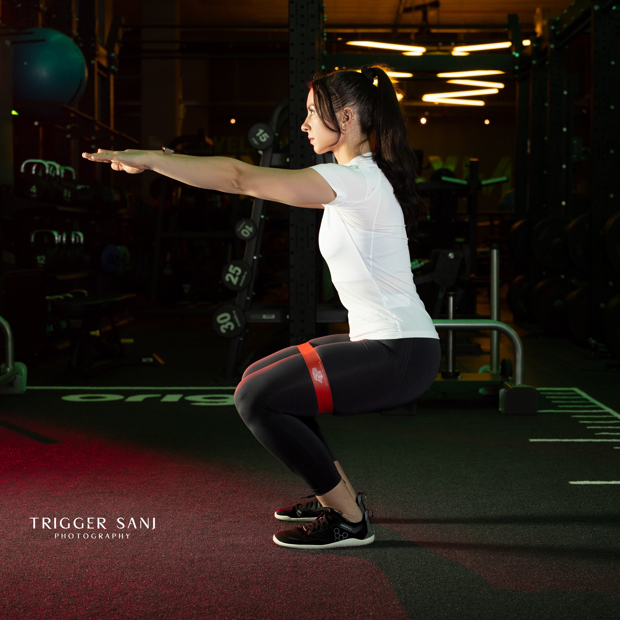 Female personal trainer using a resistance band