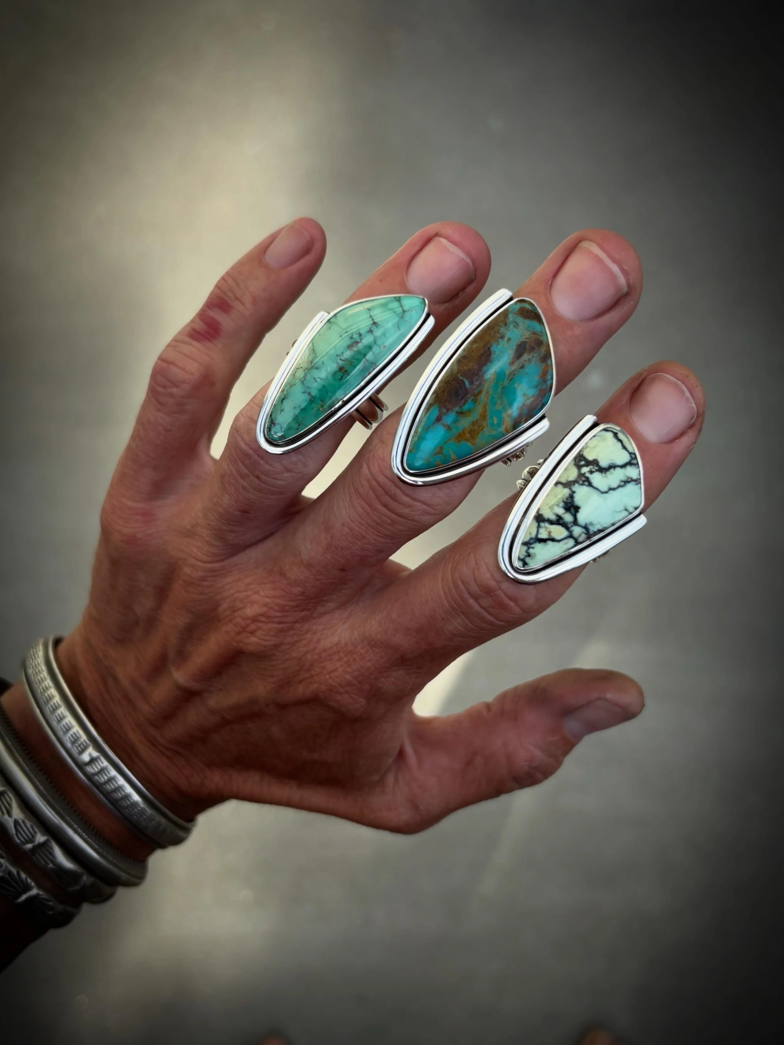 Half Wrap Rings✨✨✨

The Half Wrap is one of the original designs of the collection, this setting brings a sharp and bold look to each stone&hellip;it&rsquo;s one of my favorite designs for these sassy cut stones 🖤

Index - Saguaro Variscite - Fits s