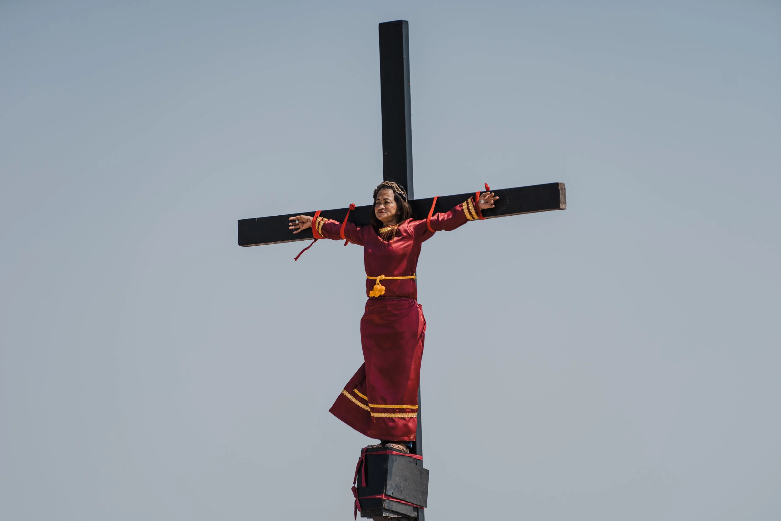  Mary Jane Sazon, the only woman to join in the crucifixion in the village this year, remains calm while she is nailed on a wooden cross as part of Good Friday rituals in the village of San Pedro Cutud, Pampanga province, northern Philippines, Friday