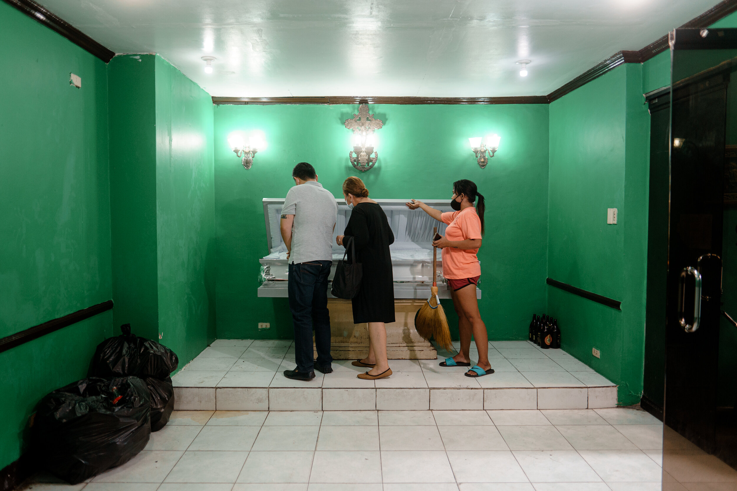  We went to the small funeral parlor's office and saw an attendant in house clothes. She suggested that we open the casket to identify who was in it and if it was who we were looking for. I volunteered. I stepped closer, lifted the lid.  It was indee