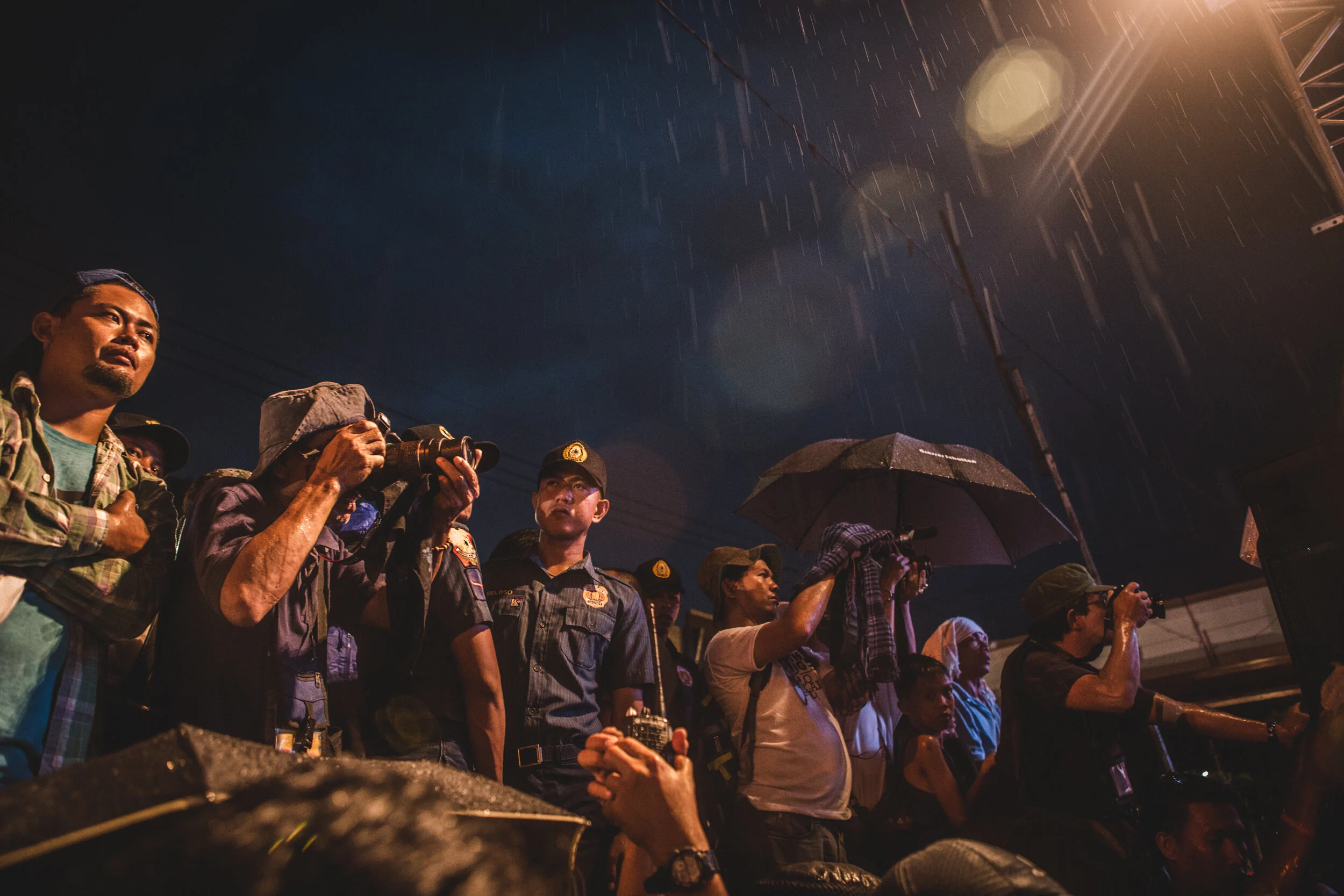  Rain poured as more police surrounded the protest in Batasan to secure the grounds for President Duterte's surprise visit after his second State of the Nation Address. July 2017. 