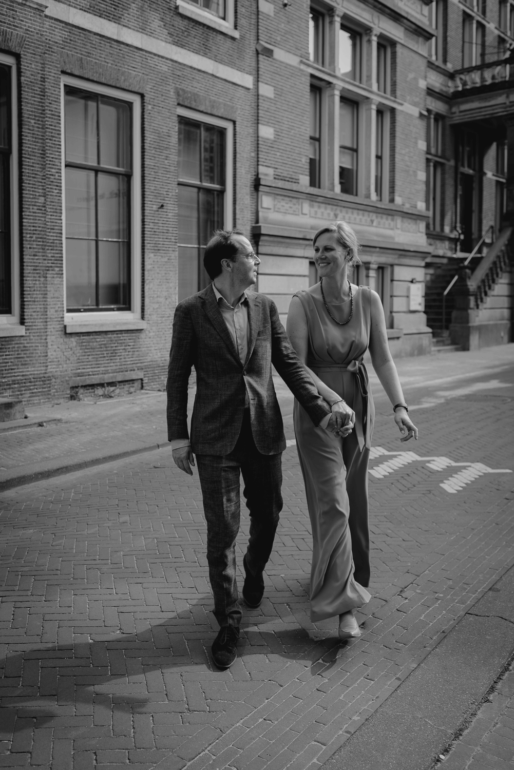 Small Wedding in Haarlem by Vicky McLachlan Photography_Bride and groom walking down the street while holding hands_1.png