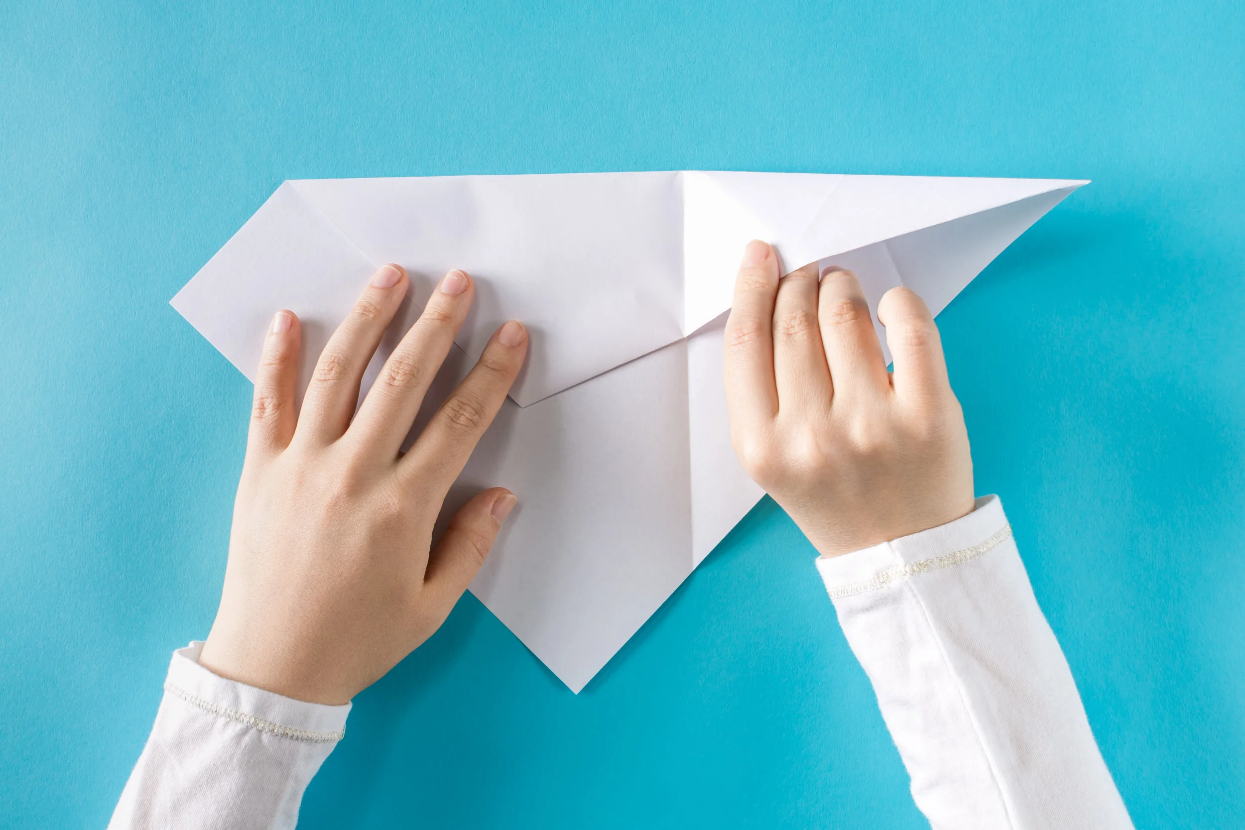 paper plane folding.jpeg