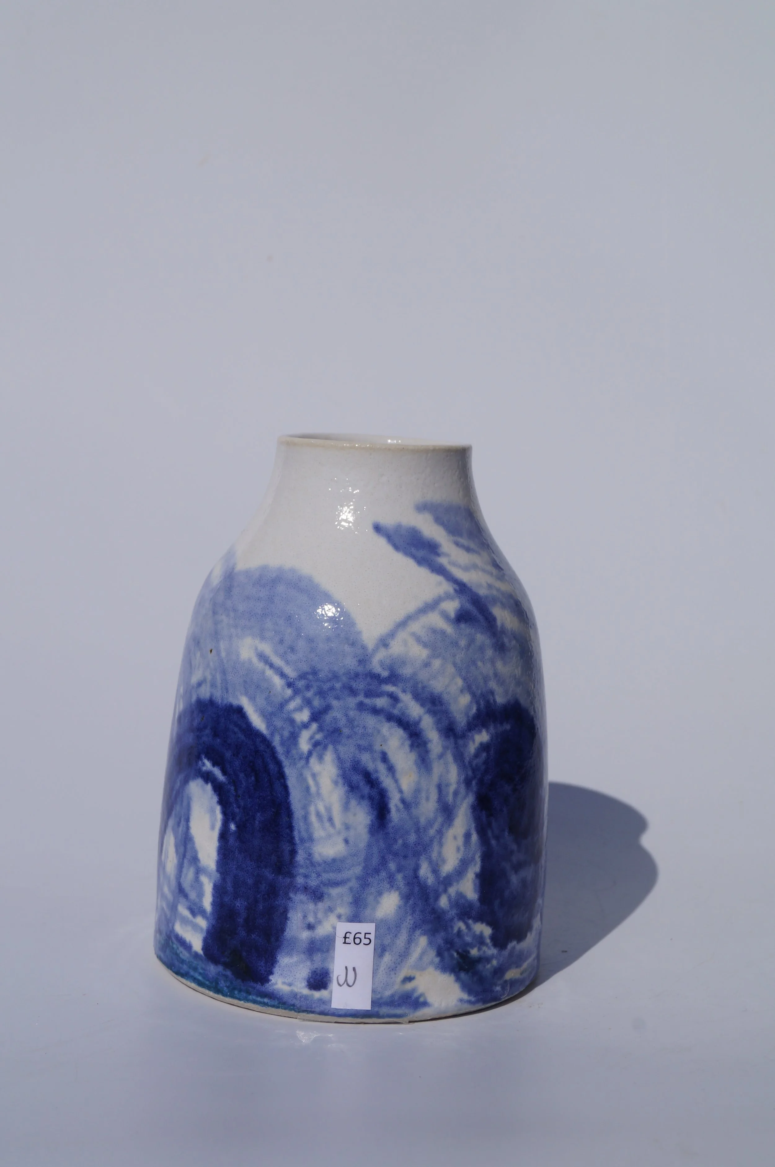 Blue and white  clouds throw bottle