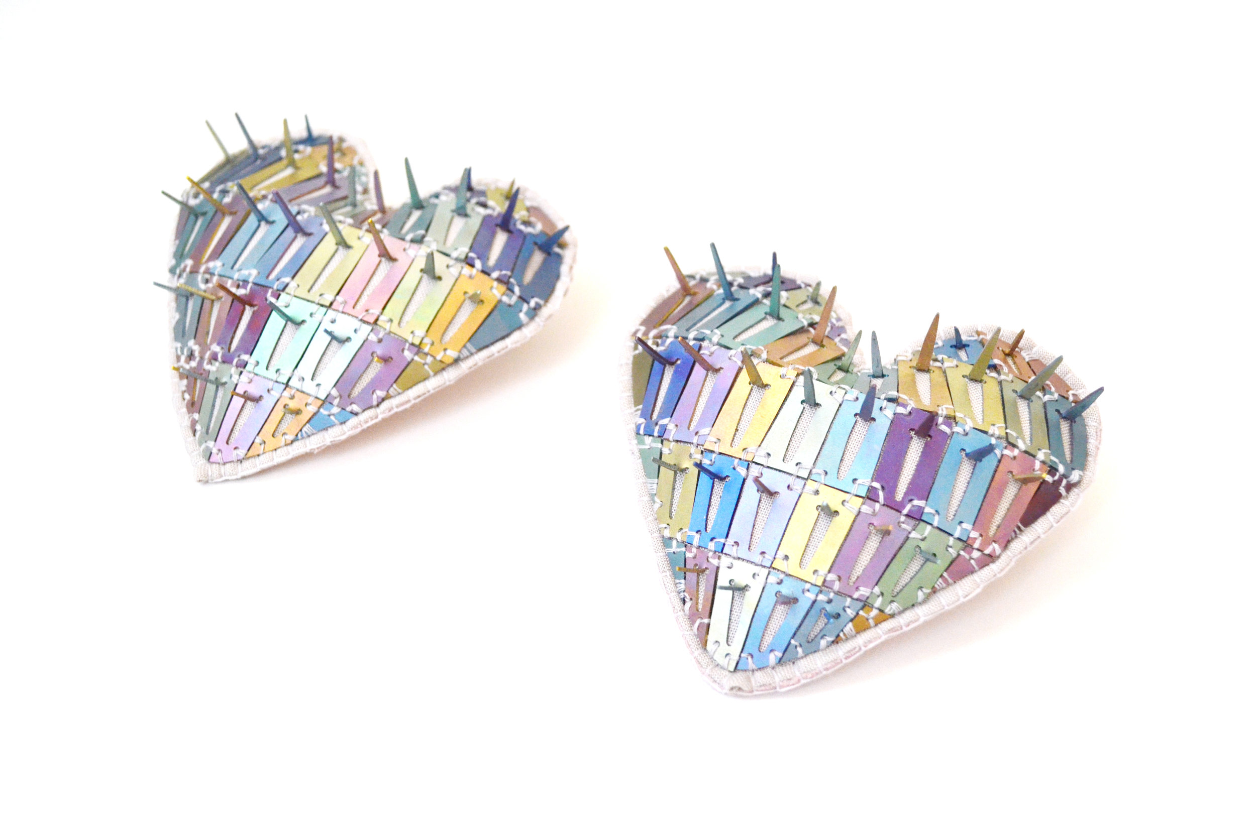   Prismatic Spikey Hearts   Anodized Titanium, Sterling Silver, Leather, Cotton, Thread  3”x3”x1” 