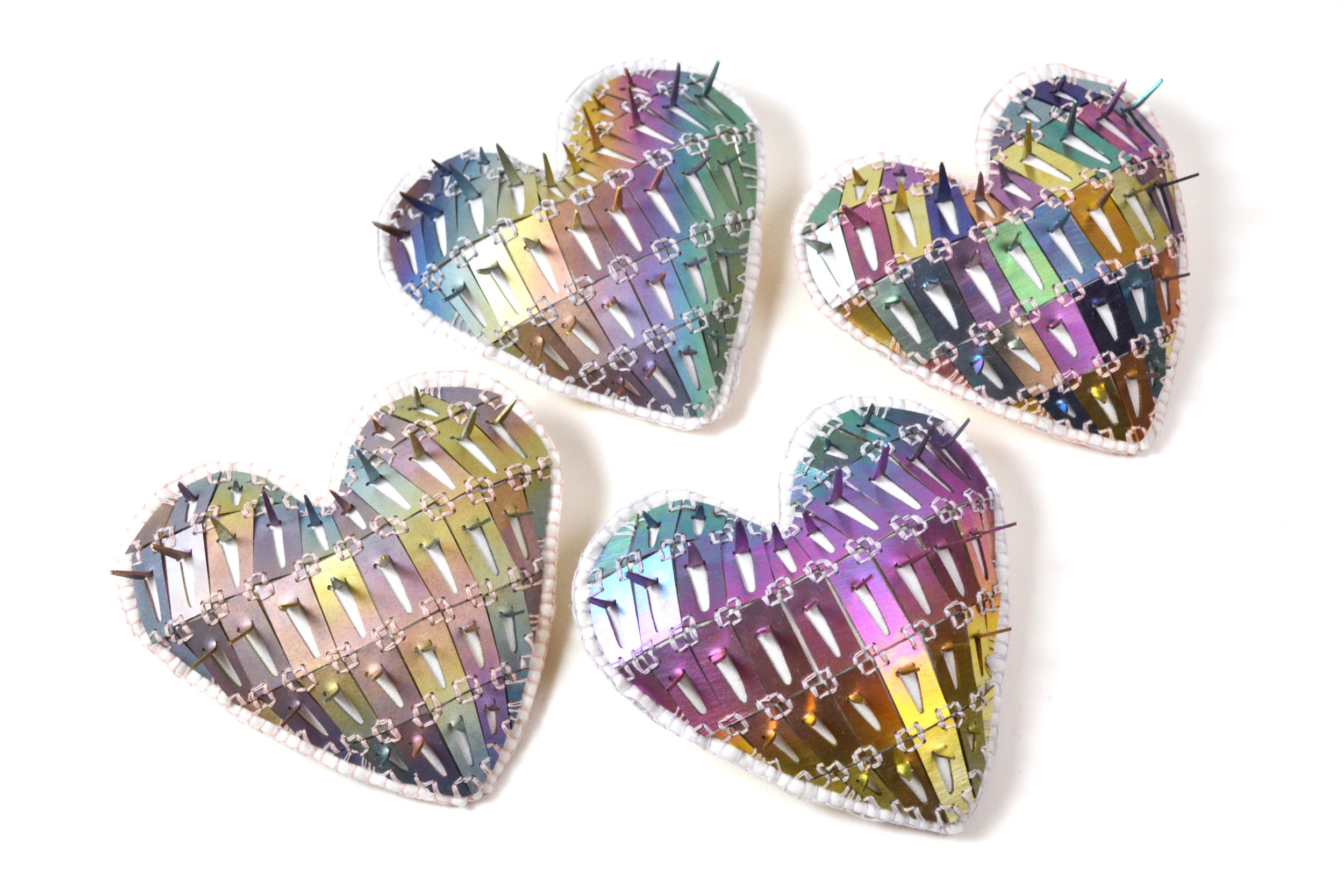   Prismatic Spikey Hearts   Anodized Titanium, Sterling Silver, Leather, Cotton, Thread  3”x3”x1” 