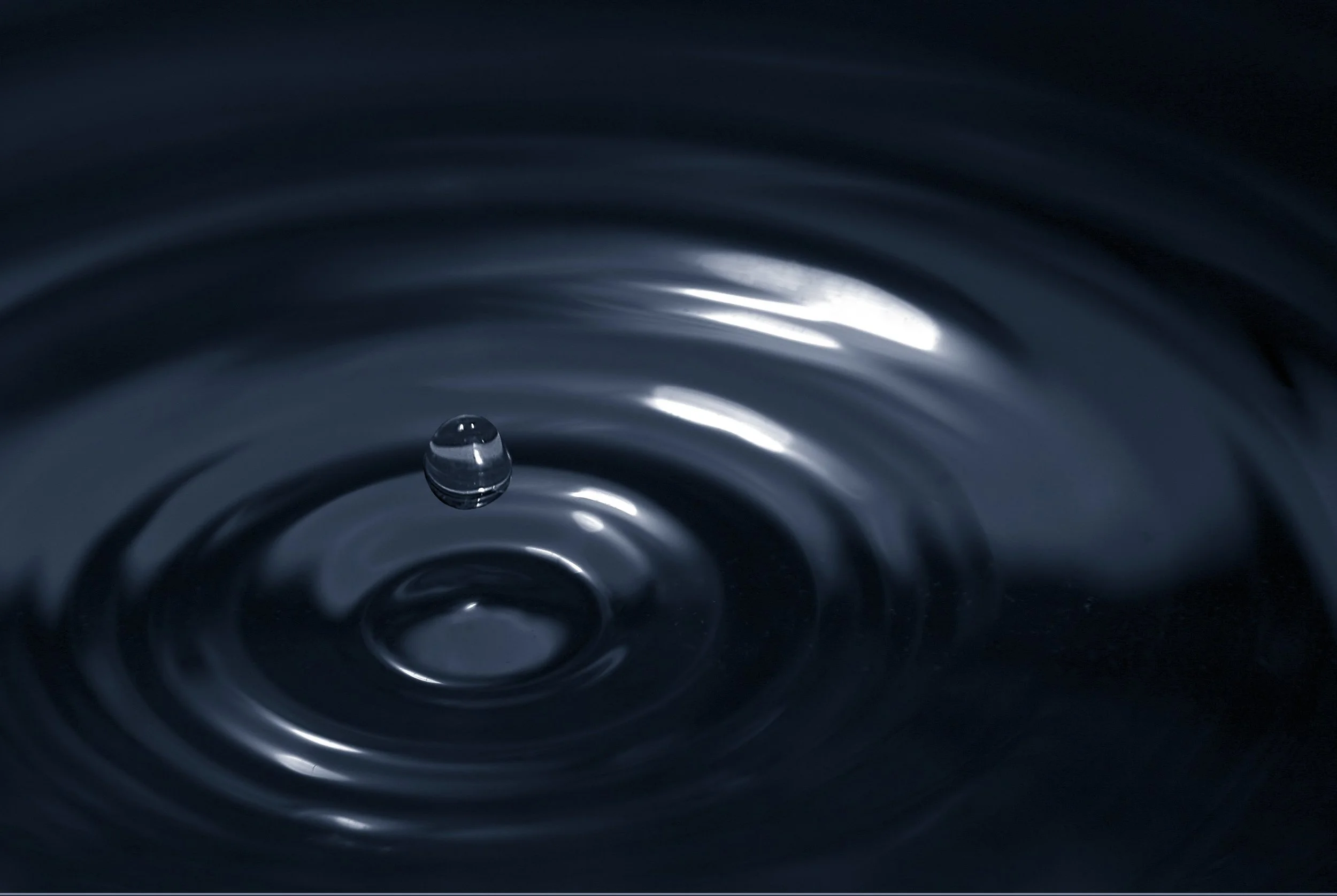 Impact of a drop of water in water, a common analogy for Brahman and the Atman and the connected spiritual oneness of all existence