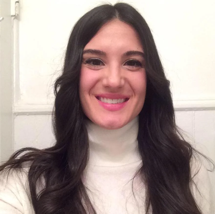 A casual headshot of Sarah Miller. The person is wearing a white turtleneck top.